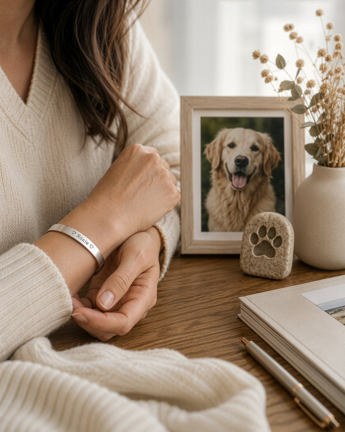 pet loss bracelet on women's wrist, dog's photo on the background
