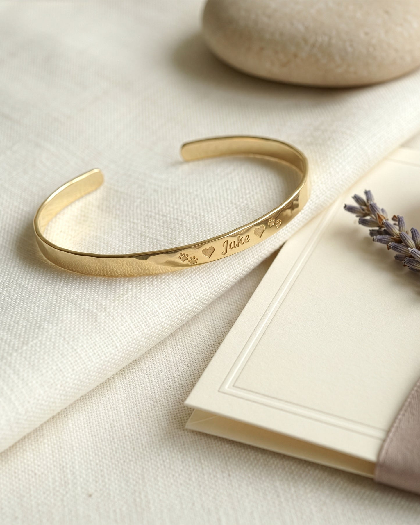 gold bracelet with name and paw print on the outside