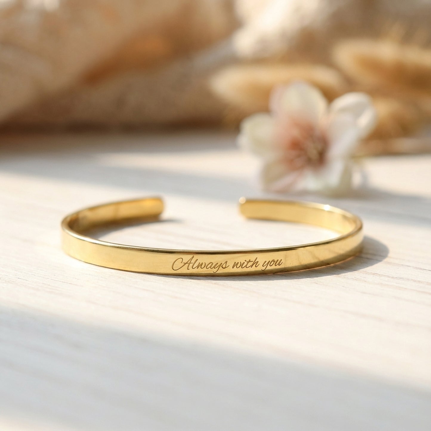 Close-up of engraving on thin gold plated cuff bracelet