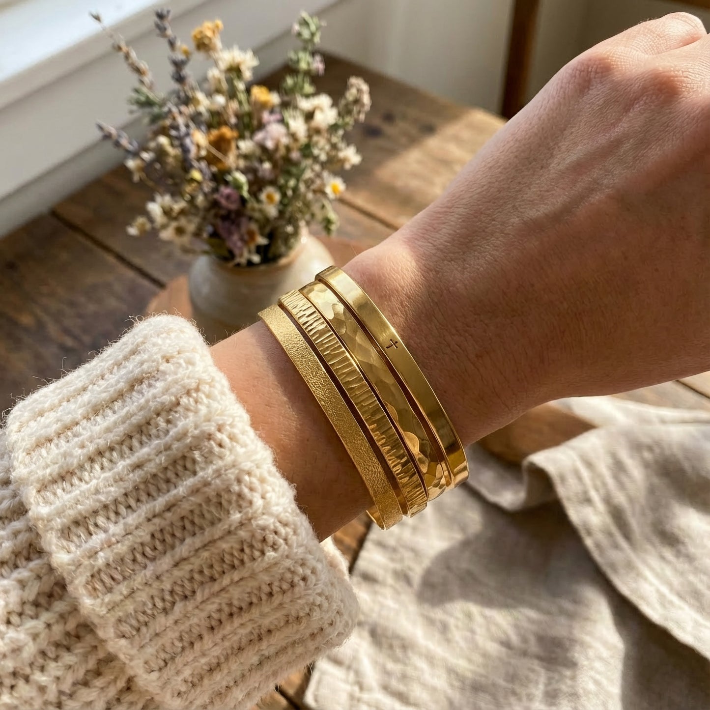 Gold plated cuff bracelets with different finish on womens wrist